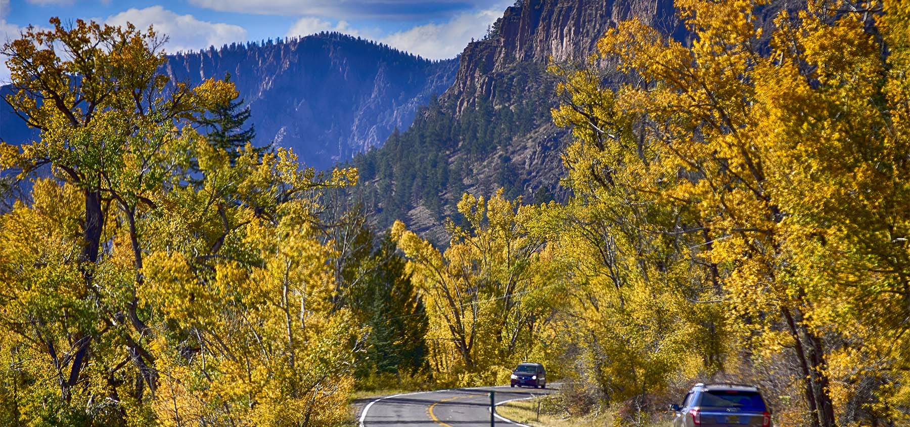 Cars drive the Silver Thread Byway in the Fall