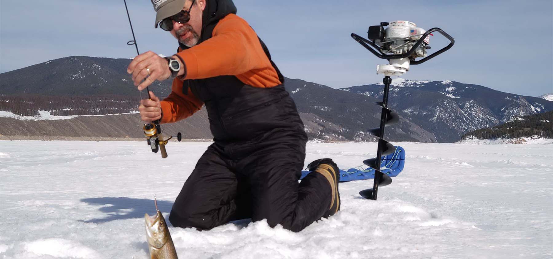 Ice Fishing in South Fork, fisherman pulling up a fish